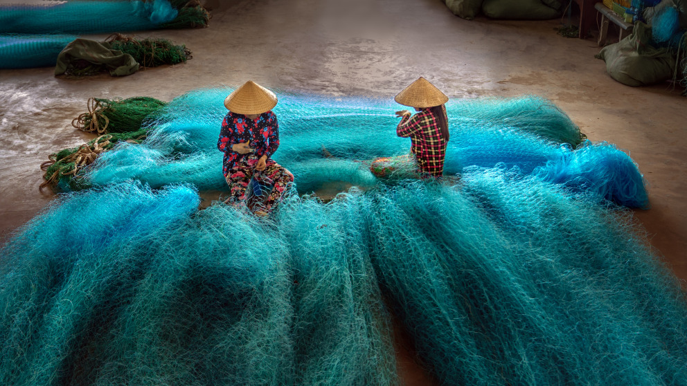 Vietnamese women are repairing fishing nets in a repair shop. Although women are engaged at all levels of interactions with the ocean, gender inequality is not uncommon across sectors.